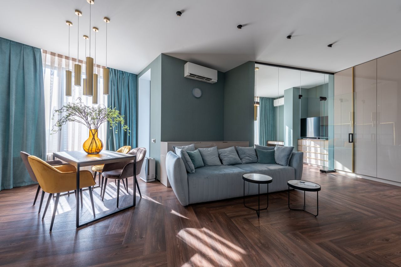 Crafting Captivating Headlines: Your awesome post title goes here Comfortable sofa and table with chairs decorated with flowers vase in modern spacious living room with wooden floor