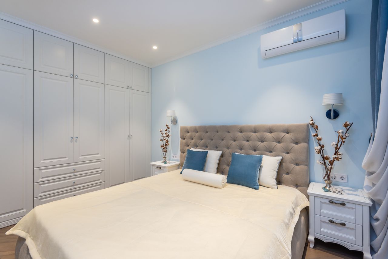 creative-approach-img Interior of classic styled bedroom with comfy bed big wardrobe and nightstands decorated with vases with cotton plants